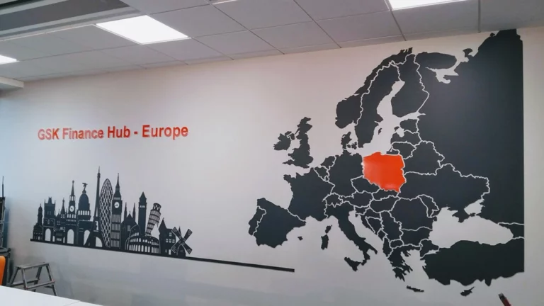 Logo firmy i mapa Europy z czarnej PCV na ścianie w biurze firmy